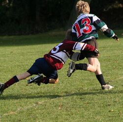 Schoolkids doing a rugby tackle.jpg