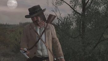 The second player character, dressed as an outlaw, looks mournfully at his gun.