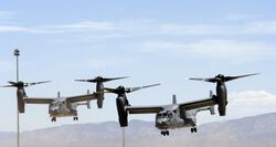 Two USAF CV-22s in a staggered pattern with their rotors vertical preparing to land at Holloman Air Force Base , New Mexico.