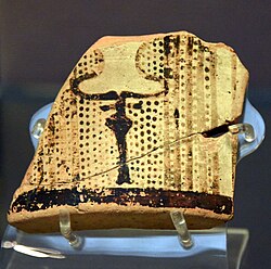 A fragment of a pottery vessel (sherd). The exterior is painted with a highly schematic bull's head and horns (bucranium). From Tell Arpachiyah, Iraq. Halaf period, 6000-5000 BCE.jpg