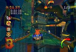 Crash Bandicoot drives his kart over a chasm in a futuristic racecourse