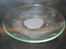 Light-gray powder on a glass dish