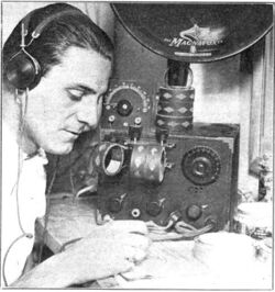 Man listening to regenerative receiver 1922.jpg