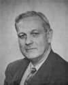 A photographic portrait of a man wearing a suit