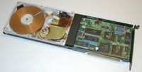 A Hardcard 20 hard disk on a card with an acrylic cover for display purposes.
