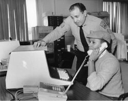 Photograph of a Boston Police staff member working at computer