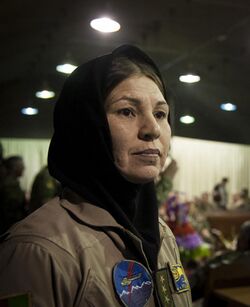 The first female Air Force helicopter pilot in Afghanistan's history Col. Latifa Nabizada exits the stage after speaking at an Afghan Air Force International Women's Day celebration at Kabul International Airport, March 07, 2013.
