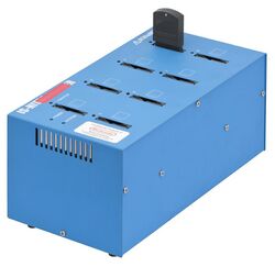Photo of a burner shown as a blue colored box with eight slots on top, and a cartridge is in one of the slots.
