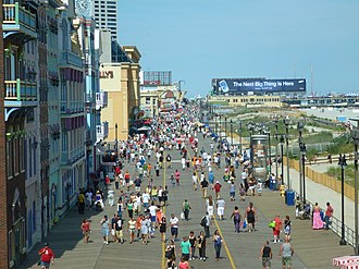 Many people walking on a boardwalk at the beach in Atlantic City, New Jersey