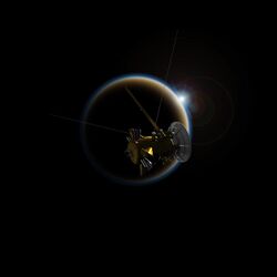 Artist's concept of the Cassini spacecraft in front of a sunset on Saturn's moon Titan