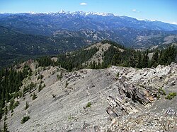 a rocky mountain slope, mostly barren at first glance
