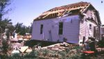 F1 tornadoes cause major damage to mobile homes and automobiles and can cause minor structural damage to well-constructed homes. This frame home sustained major roof damage, but otherwise remained intact.