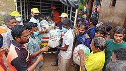 Volunteers of Sanatan Sanstha distributing relief-material to flood victims.jpg