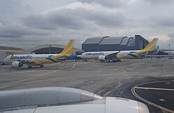 Cebu Pacific's A330-900neo (right) and A320neo (left) parked at Ninoy Aquino International Airport.