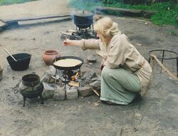 Reconstruction of Iron Age cookery with iron trivets over a fire.jpg