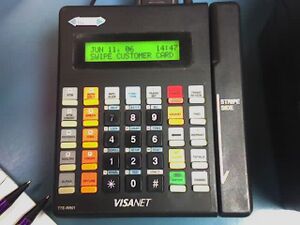 A typical credit card terminal popular in 2005, now typically out of use and of a style/era usually non-compliant per PCI-DSS standards.