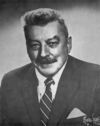 A photographic portrait of a man wearing a suit