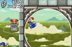Screenshot showing Sonic running around a loop in Angel Island zone, the game's fifth level. The HUD on the upper left-hand corner shows the timer, score, and amount of rings the player has.