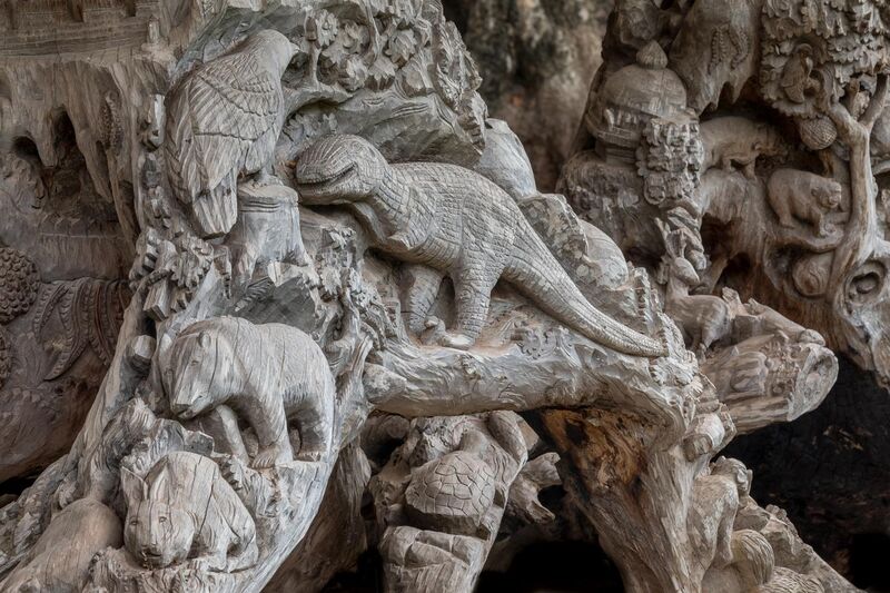 File:Carved tree with reliefs of dinosaur and other animals.jpg