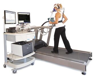 Person on a treadmill wearing a mask connected to a metabolic cart