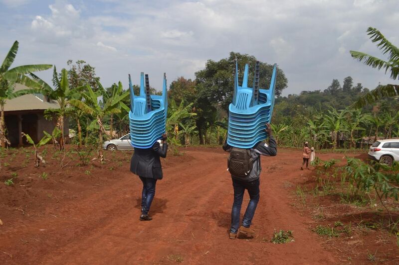 File:People carrying chairs.jpg