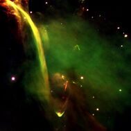 Yellow-green emission cap produced by red jet from a star in a deep green nebula