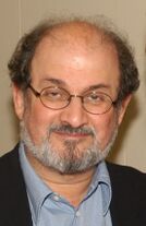 Salman Rushdie, partially bald, bearded, and wearing glasses