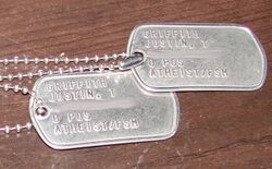 two metal US Army dog tags with Atheist/FSM stamped on them.