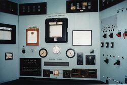 A control panel with lots of switches and meters