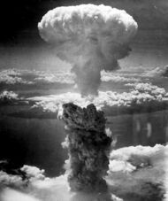 Photo of an atomic explosion mushroom cloud with a gray stem and white cap