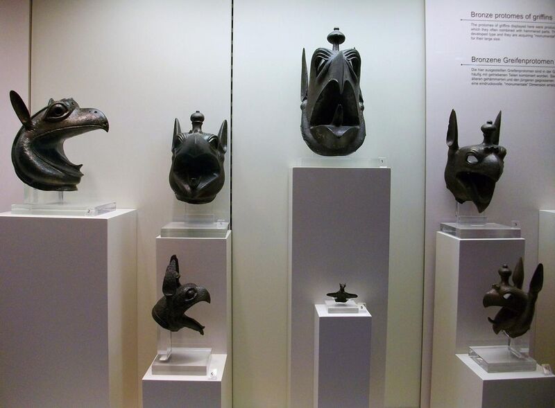 File:Pròtoms de bronze amb forma de grifons, segle VII aC. Museu Arqueològic d'Olímpia.JPG