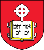 Coat of arms of the school, containing a book device inscribed with Hebrew letters and cross in front of a red background