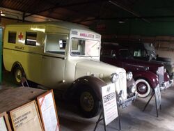 Bletchley Park Garage Austin 18 and Land Rover Ambulances.jpg