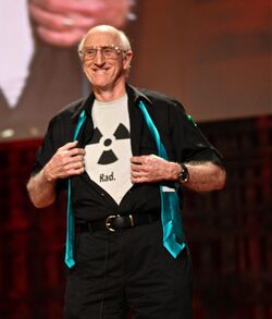 Stewart Brand wearing a shirt bearing the radioactive trefoil symbol with the caption "Rad."