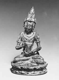 Seated Male Deity Holding a Cuirass (Chest Armour) last quarter of the 10th–first half of the 11th century.jpg