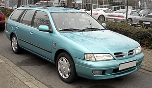 Front-three-quarter view of a five-door estate car with wing mirrors, roof bars, and flush headlights