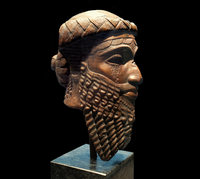 A bronze head artefact, with the beard depicted prominently. The artefact is believed to illustrate the Akkadian god-king Naram-Sin, or his grandfather Sargon of Akkad.