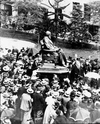 Unveiling of the bronze Darwin Statue outside the former Shrewsbury School building in 1897 surrounded by schoolboys in straw hats