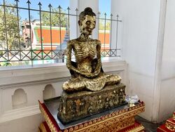 Wat Suthat วัดสุทัศน์ - emaciated fasting Buddha.jpg