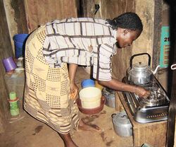 A Nigerian woman demonstrates her daily use of the Clean Cook Stove