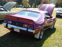 shows the rear end of a 1973 Javelin AMX finished in purple