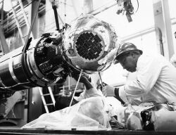 An engineer from Ling-Tempco-Vought makes final adjustments to a SECOR Satellite