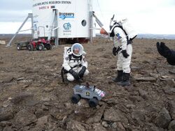 Crew members Joseph Palaia and Vernon Kramer deploy the Omega Envoy prototype lunar rover on July 12, 2009.