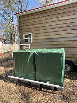Rainwater is collected from a rooftop of a tiny house and then diverted into two 275 gallon IBC totes. This is an affordable way to capture water for the gardens, livestock, and other land lab uses.