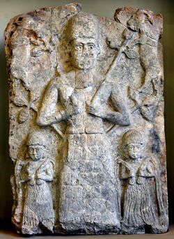 Cult wall relief from Assur. A deity, probably god Assur, is flanked by 2 water deities and 2 goats. 2000-1500 BCE. Pergamon Museum, Berlin.jpg