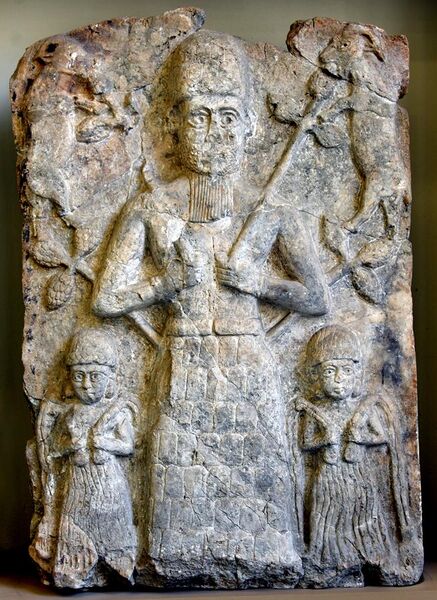 File:Cult wall relief from Assur. A deity, probably god Assur, is flanked by 2 water deities and 2 goats. 2000-1500 BCE. Pergamon Museum, Berlin.jpg