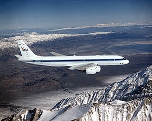 DC-8 Airborne Laboratory in flight over snow-capped Sierra Nevada mountain range.jpg