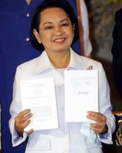President Gloria Macapagal-Arroyo shows a copy of Republic Act No. 9711.jpg