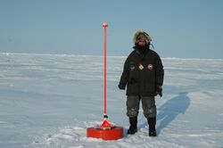 Dr. Pablo Clemente-Colon next to a Metocean ice beacon on a frigid early spring day - NOAA Photo Library.jpg