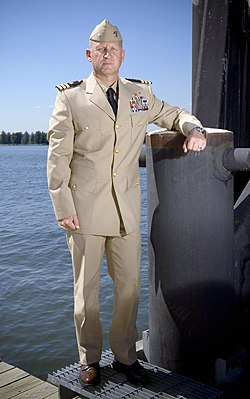 US Navy 070919-N-5319A-011 A Sailor shows off the prototype uniform for service dress khaki, a throwback to the traditional WWII style uniform.jpg